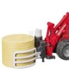 Cargadora compacta Schäffer 2630 con pinza para pacas y 1 paca redonda