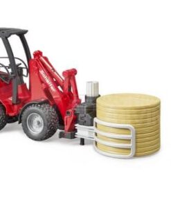 Cargadora compacta Schäffer 2630 con pinza para pacas y 1 paca redonda